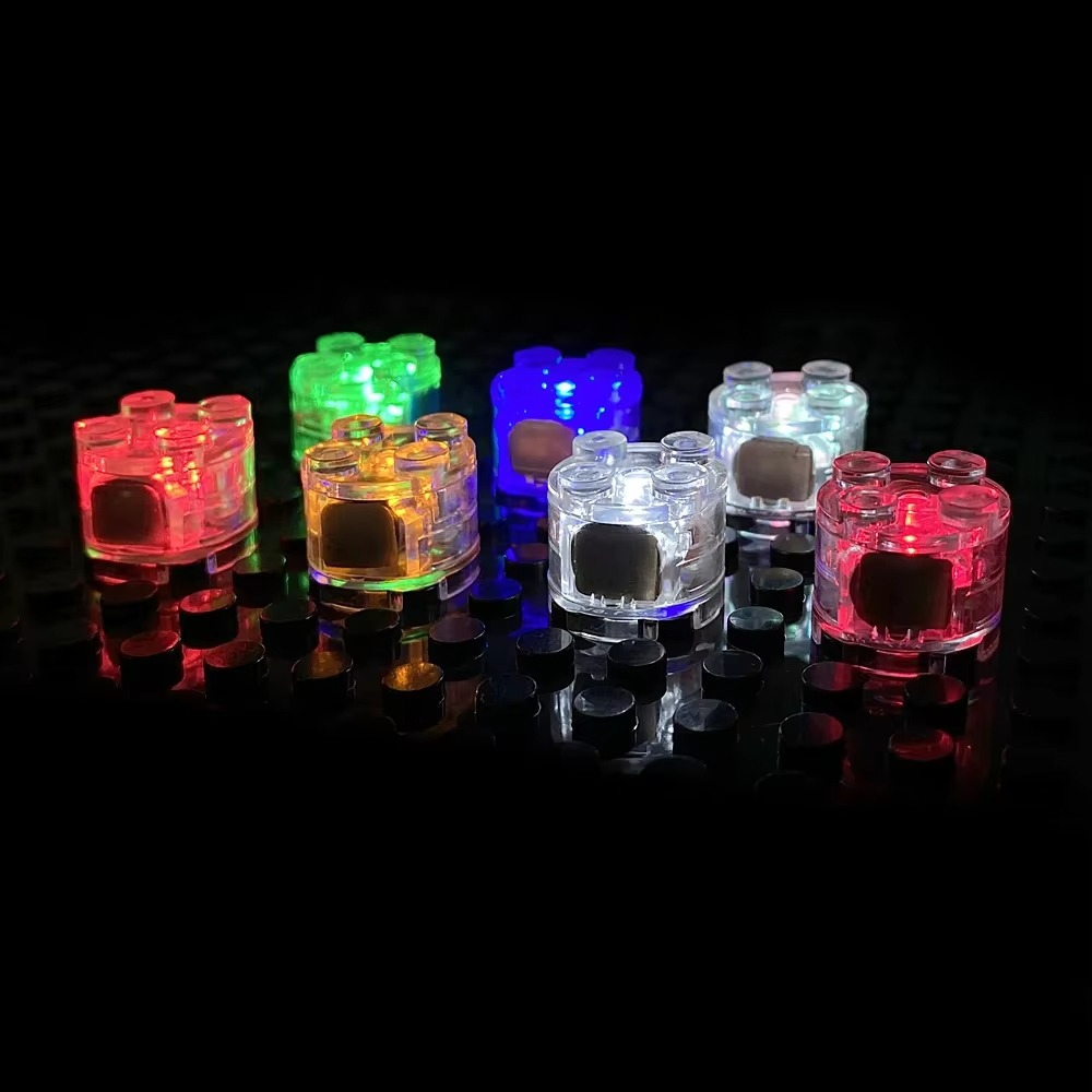 https://cdn.shopify.com/s/files/1/0743/8945/5069/files/Puzzloria_LED_building_block_lights_2x2_multicolor_light_up_bricks_compatible_with_standard_building_blocks.png?v=1764339783