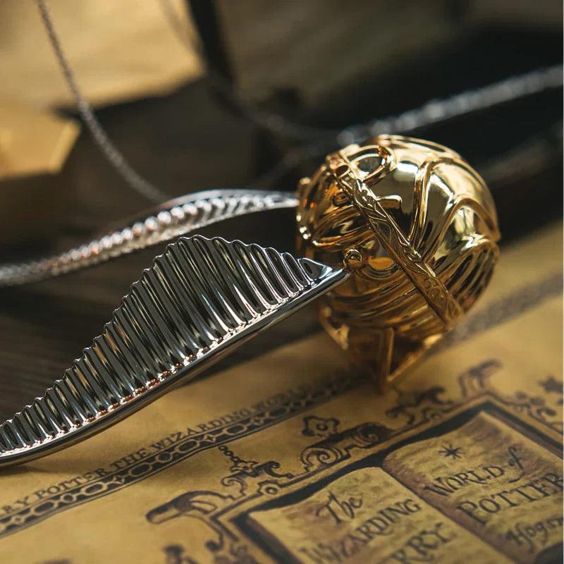 https://cdn.shopify.com/s/files/1/0743/8945/5069/files/puzzloria-3d-metal-puzzle-gold-puzzloria-golden-snitch-ring-box-43347441516765.webp?v=1747754526