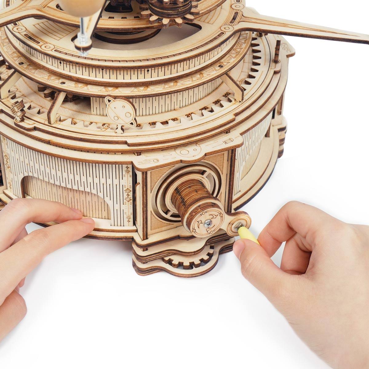 https://cdn.shopify.com/s/files/1/0743/8945/5069/files/puzzloria-3d-wooden-puzzle-deluxe-wooden-orbital-puzzloria-celestial-explorer-mechanical-orrery-43347851444445.jpg?v=1745185539