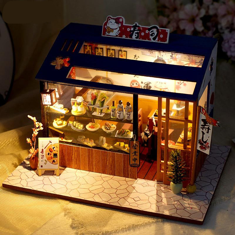 https://cdn.shopify.com/s/files/1/0743/8945/5069/files/puzzloria-diy-miniature-cute-sushi-puzzloria-diy-dollhouse-kit-dream-shop-1-43347882836189.jpg?v=1745185768