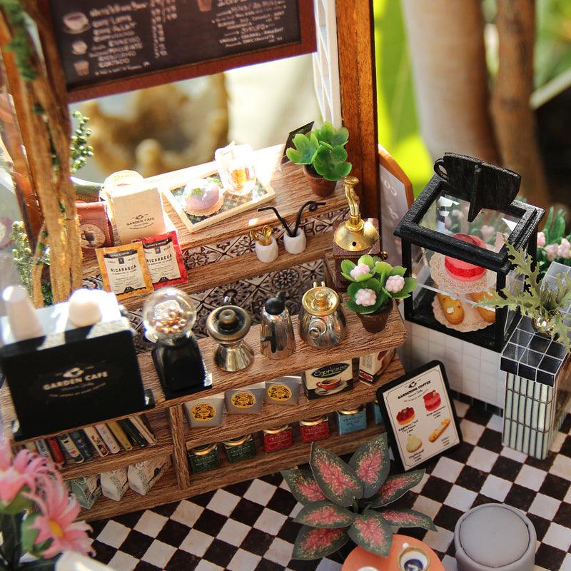 https://cdn.shopify.com/s/files/1/0743/8945/5069/files/puzzloria-diy-miniature-default-title-puzzloria-diy-dollhouse-kit-garden-cafe-43347898433757.jpg?v=1749504145