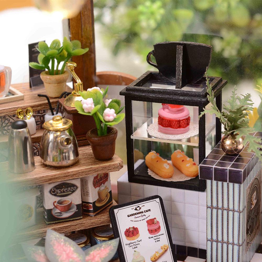 https://cdn.shopify.com/s/files/1/0743/8945/5069/files/puzzloria-diy-miniature-default-title-puzzloria-diy-dollhouse-kit-garden-cafe-43347898466525.jpg?v=1749504145
