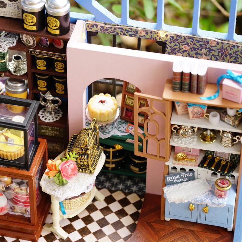 https://cdn.shopify.com/s/files/1/0743/8945/5069/files/puzzloria-diy-miniature-default-title-puzzloria-diy-dollhouse-kit-rose-garden-tea-house-43347931791581.jpg?v=1745185800