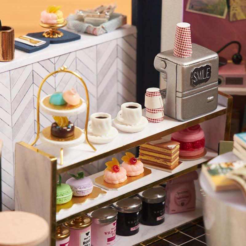 https://cdn.shopify.com/s/files/1/0743/8945/5069/files/puzzloria-diy-miniature-default-title-puzzloria-dollhouse-kit-book-cafe-43347875922141.jpg?v=1745185972