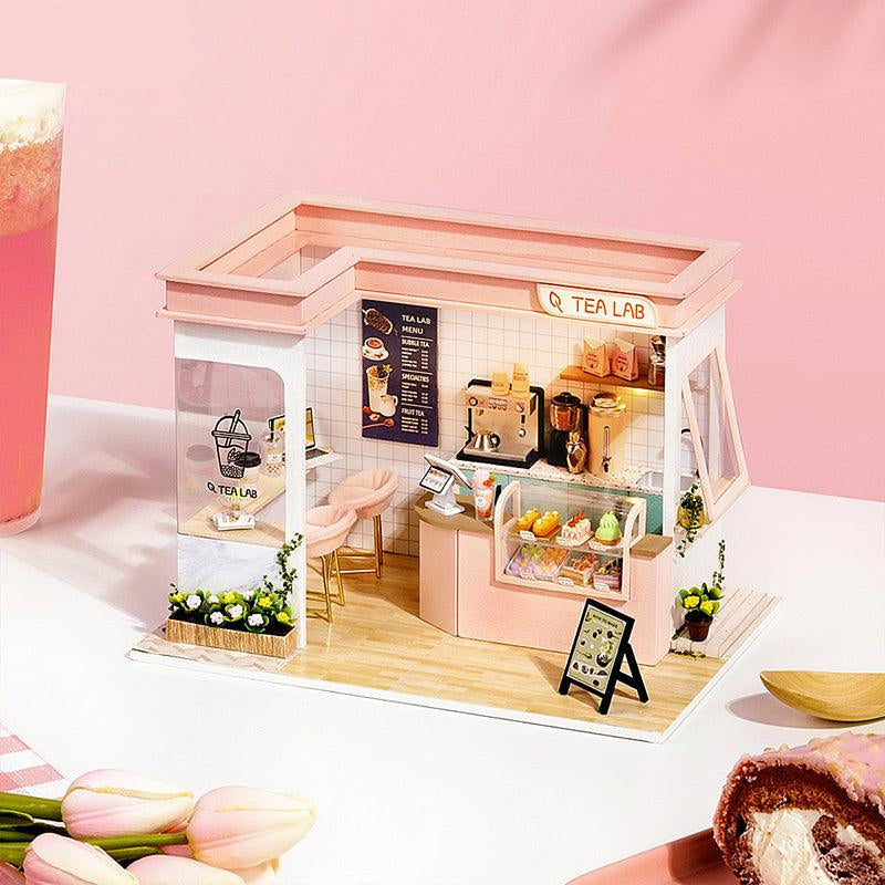 https://cdn.shopify.com/s/files/1/0743/8945/5069/files/puzzloria-diy-miniature-pink-puzzloria-diy-dollhouse-kit-happy-shop-series-43347879231709.jpg?v=1747661640